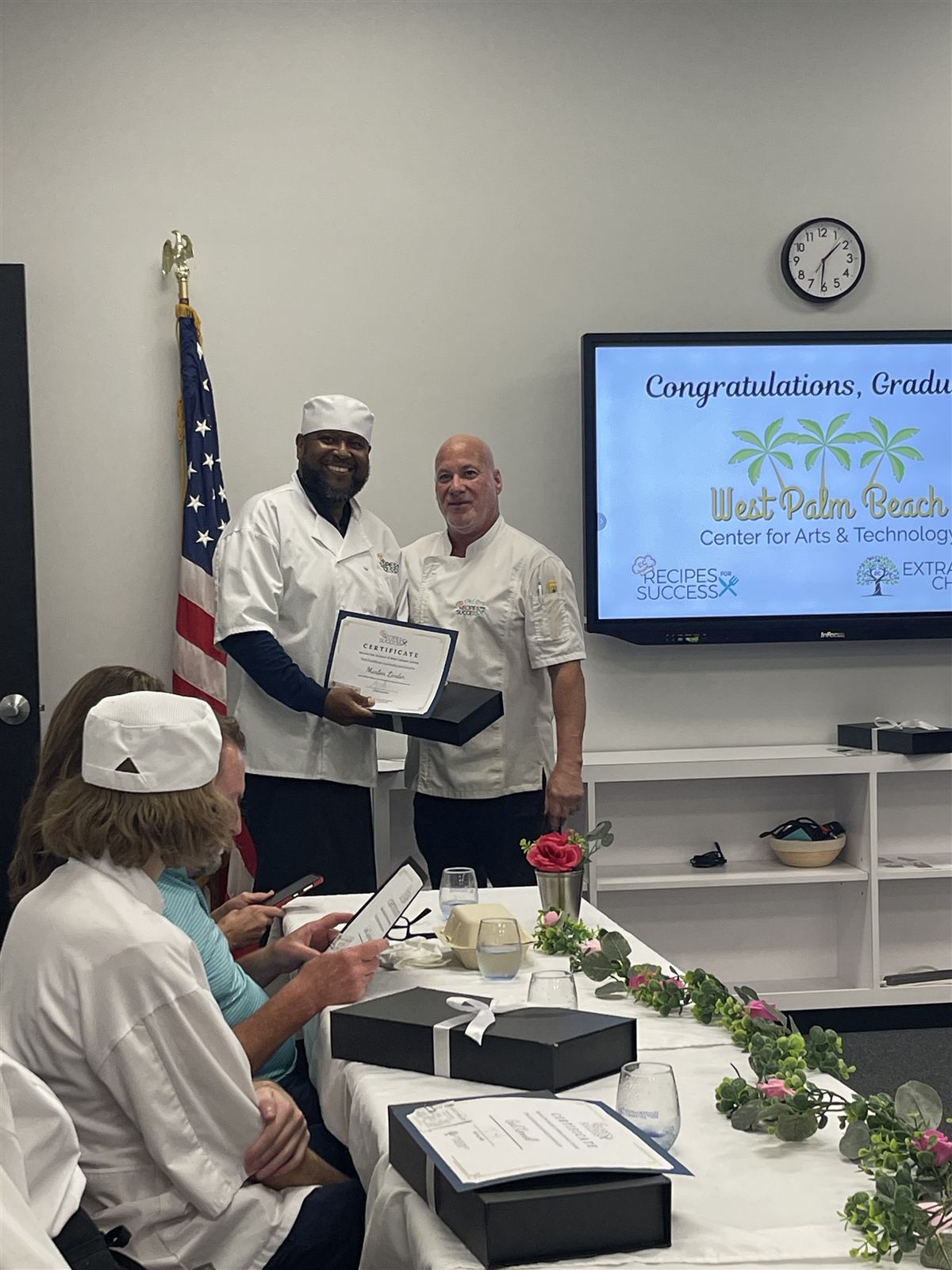 Graduate Marlon Lindor celebrating with a certificate at the WPBCAT Culinary Workforce Development graduation