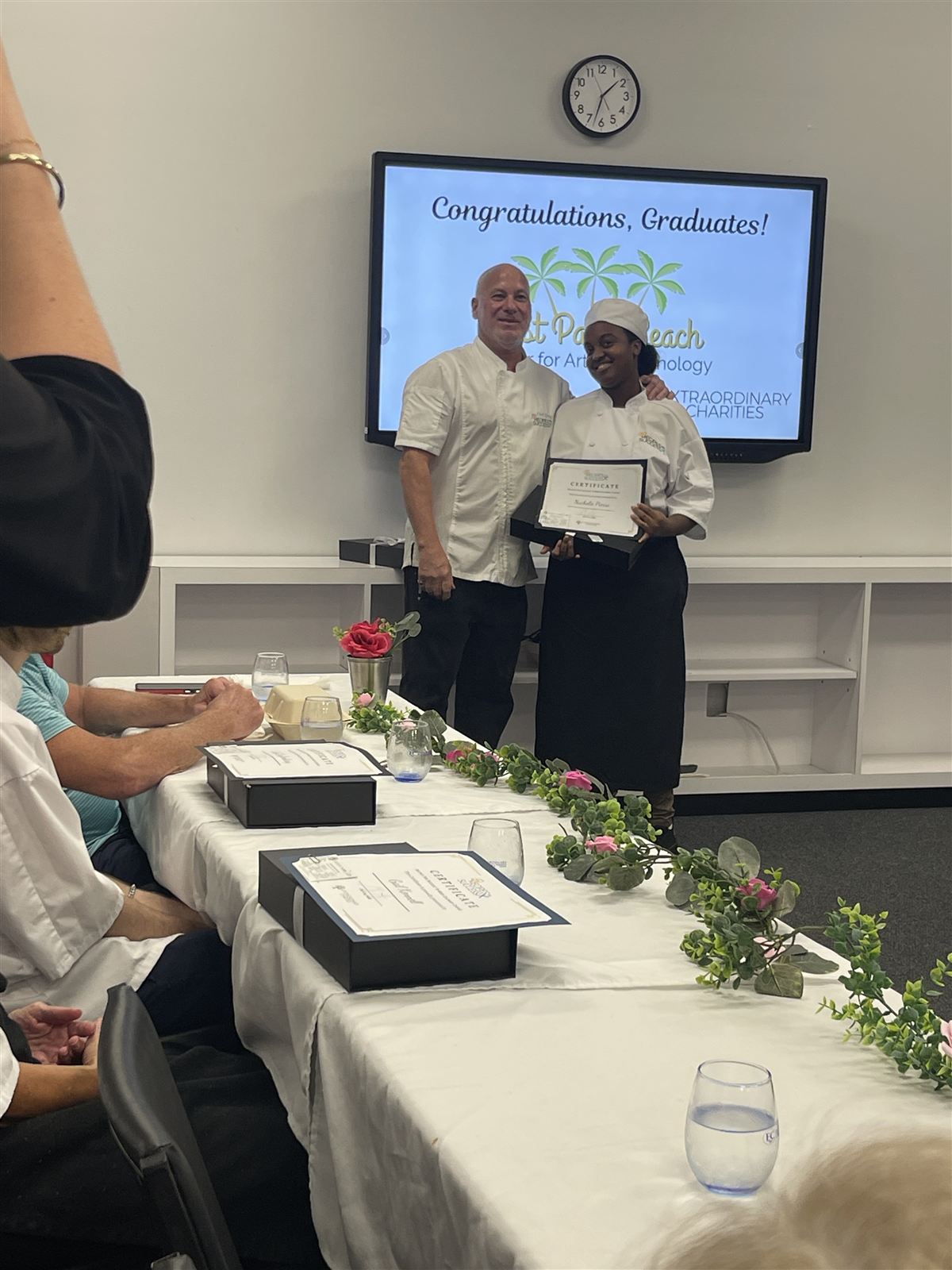 Graduate Nachelie Pierre receiving her certificate at the WPBCAT Culinary Workforce Development graduation